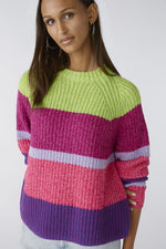 Oui Broad Stripes Jumper. An oversized fit jumper with shortened length. This jumper has long sleeves, round neckline, and a multi-coloured green, pink and purple striped pattern.