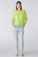 Oui Rouched Waistband Jumper. A narrow cut, long sleeve jumper with round neck and knot hem detail. This jumper is in a bright green shade and has ribbed detail.