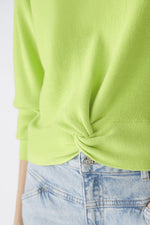 Oui Rouched Waistband Jumper. A narrow cut, long sleeve jumper with round neck and knot hem detail. This jumper is in a bright green shade and has ribbed detail.