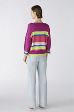 Oui Tie Sides Jumper. This jumper has a casual cut and regular length, alongside 3/4 length sleeves, round neck with overcut shoulder, tie side detail, and a bold striped print in pink, purple, blue and green.