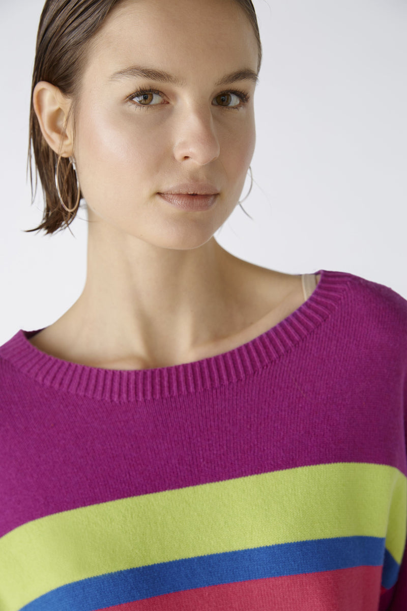 Oui Tie Sides Jumper. This jumper has a casual cut and regular length, alongside 3/4 length sleeves, round neck with overcut shoulder, tie side detail, and a bold striped print in pink, purple, blue and green.