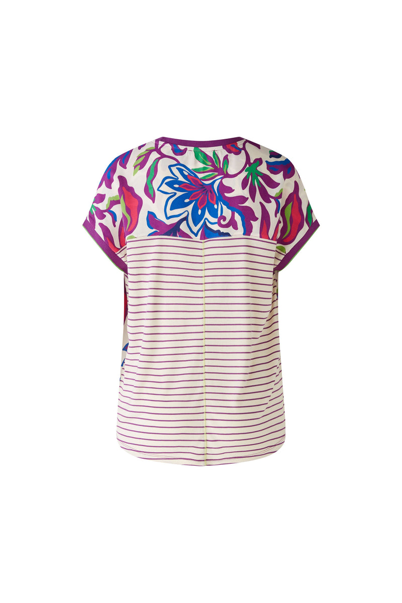 Oui Bottom Floral Blouse. An oversized cut, regular length top with short sleeves and round neckline. The neckline and armholes are a contrasting colour, whilst the front design is floral and the back is striped. This blouse is multicoloured and purple.