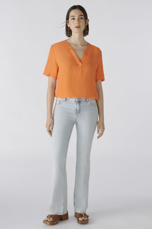 Oui V-Neck Blouse. An orange, relaxed fit blouse with short sleeves and V-neck.