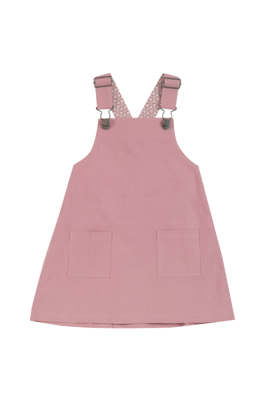 Pigeon Organics Dungaree Dress. A pink dungaree dress with two front pockets.
