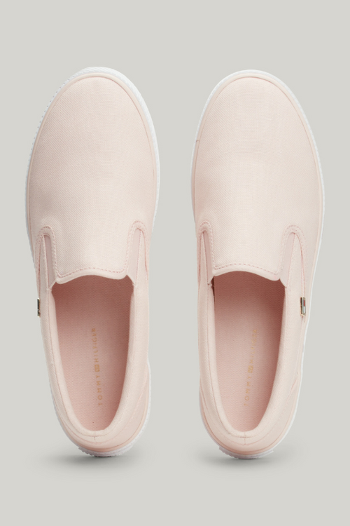 An image of the Tommy Hilfiger Enamel Flag Slip-On Canvas Trainers in the colour Whimsy Pink.