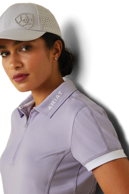 An image of a female model wearing the Ariat Bandera 1/4 Zip Short Sleeved Polo Shirt in the colour Lilac.