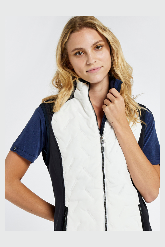 Dubarry Redbarn Gilet in White with Navy detail on the sides. A zip-up gilet with a dipped back hem and rib knit cuff detail