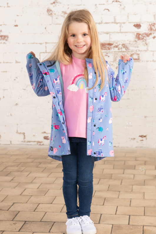 Lighthouse Olivia Jacket. A lightweight, waterproof kids coat with a soft jersey lining, two front pockets, a zip-up front, and a cute farm animal design on a lilac background.