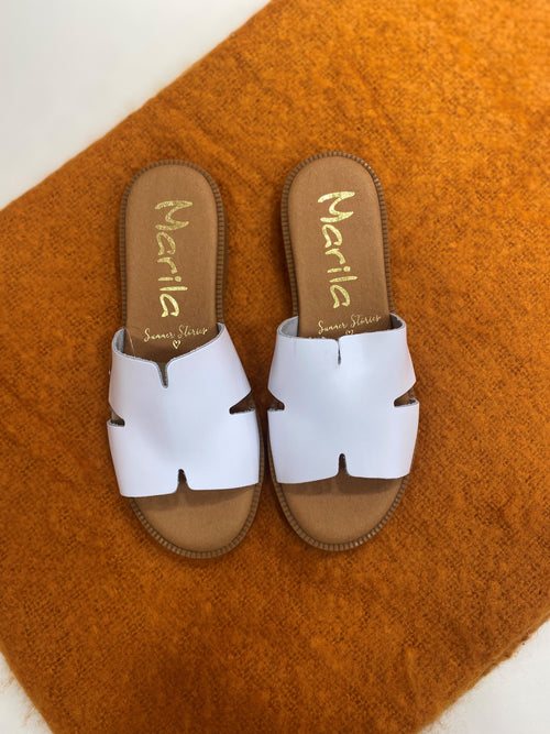 Marila Flat Slider. A pair of leather slider sandals with wide white strap design.