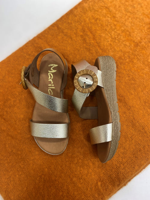 Marila Sling Back Sandal. A pair of sandals with shiny silver straps and statement buckle.