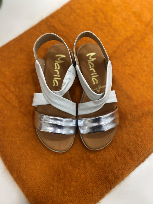 Marila Sling Back Sandal. A pair of low wedge sandals with white cross-over straps and shiny strap.