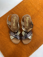 Marila Sling Back Sandal. A pair of low wedge sandals with cross-over metallic strap design.