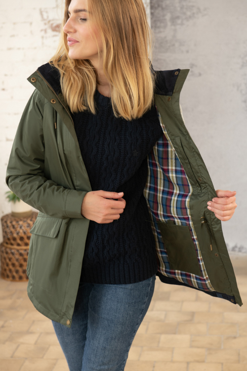 Lighthouse Kendal Raincoat. A fully lined, waterproof jacket with pockets, a two-way zip, a flattering hip length style, and a forest green colour design.