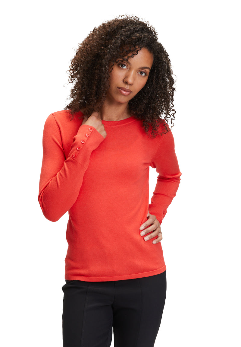 An image of the Betty Barclay Fine Knit Top in red, with long sleeves featuring a button detail.