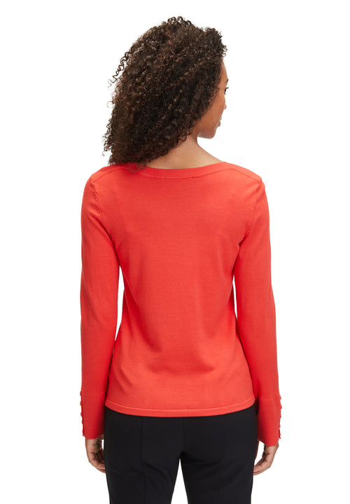 An image of the Betty Barclay Fine Knit Top in red, with long sleeves featuring a button detail.