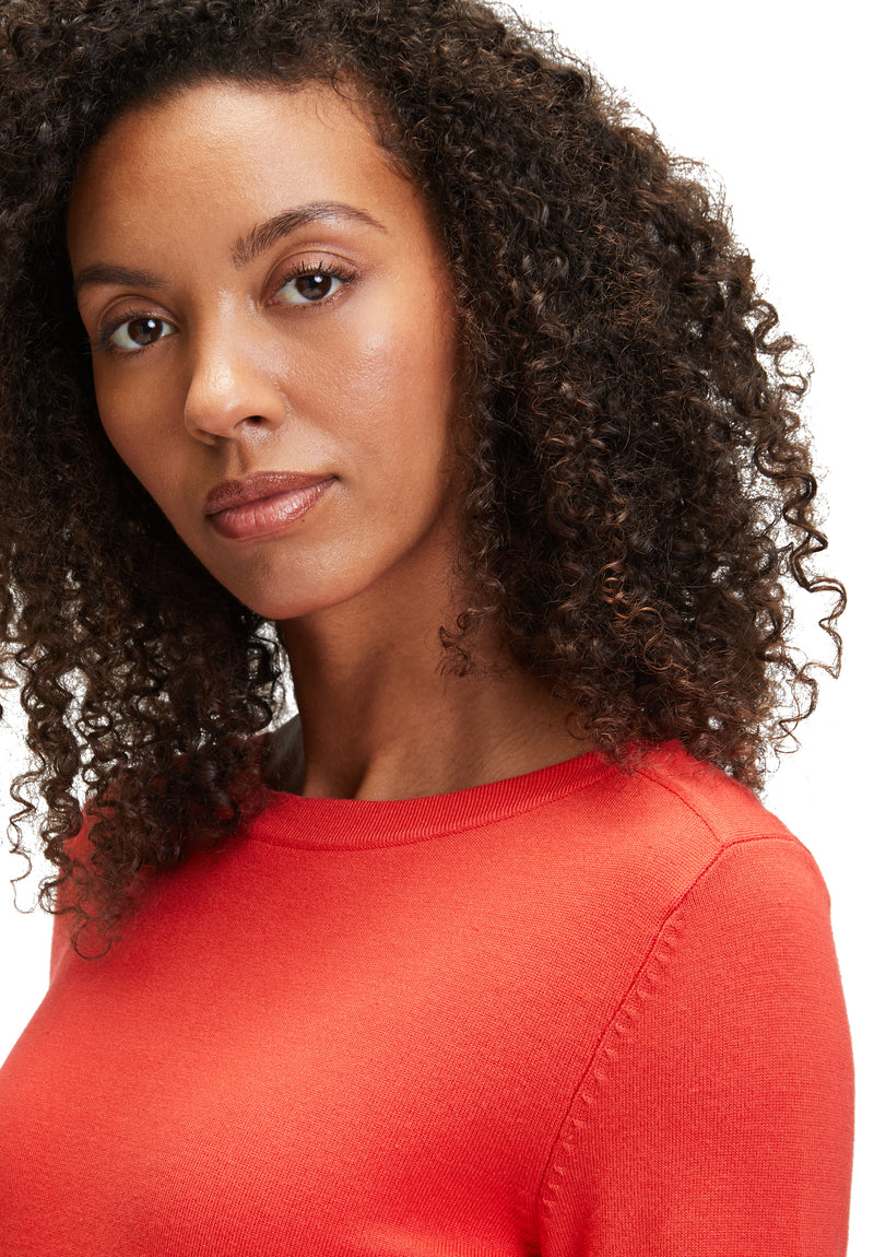 An image of the Betty Barclay Fine Knit Top in red, with long sleeves featuring a button detail.