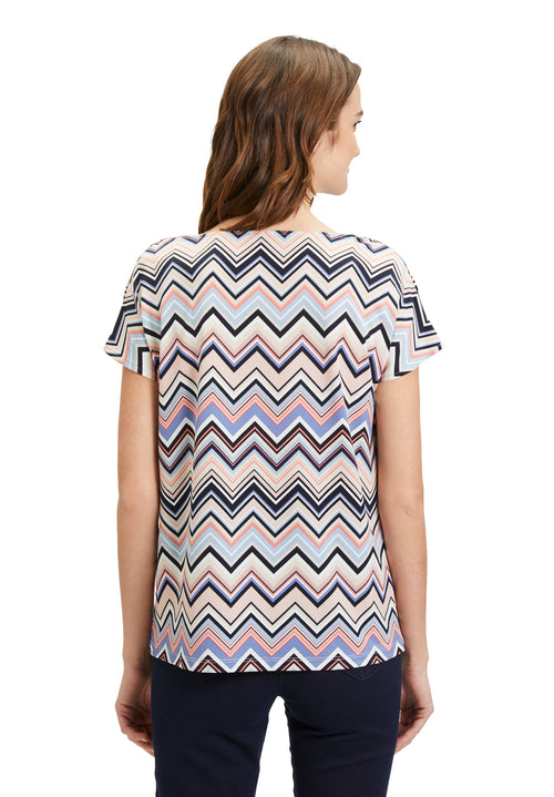 This Betty Barclay Printed Top has a figure-skimming design, dropped mid-length sleeves and a cowl neckline. It features a zig-zag pattern in multiple pastel colours including blue and pink. 