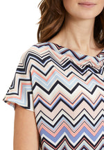 This Betty Barclay Printed Top has a figure-skimming design, dropped mid-length sleeves and a cowl neckline. It features a zig-zag pattern in multiple pastel colours including blue and pink. 