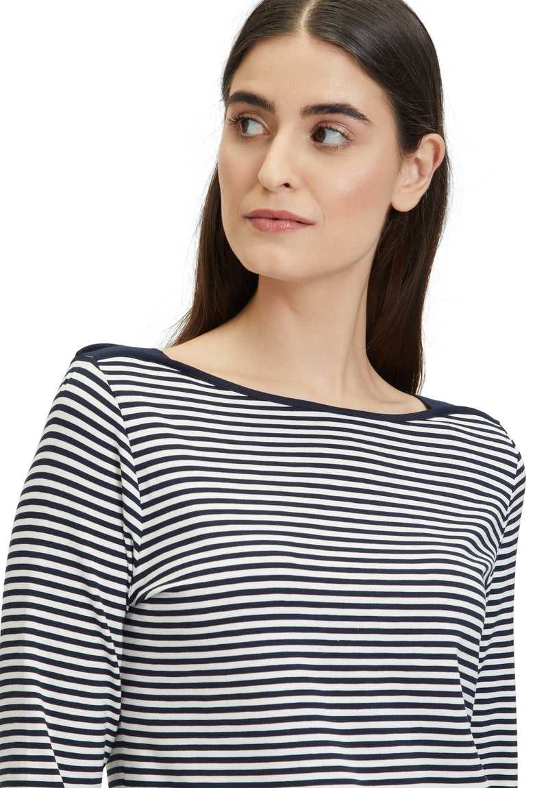 This Betty Barclay Striped Top has a bateau neckline and 3/4 length sleeves. This top is slightly fitted and has a dark blue and white striped pattern.