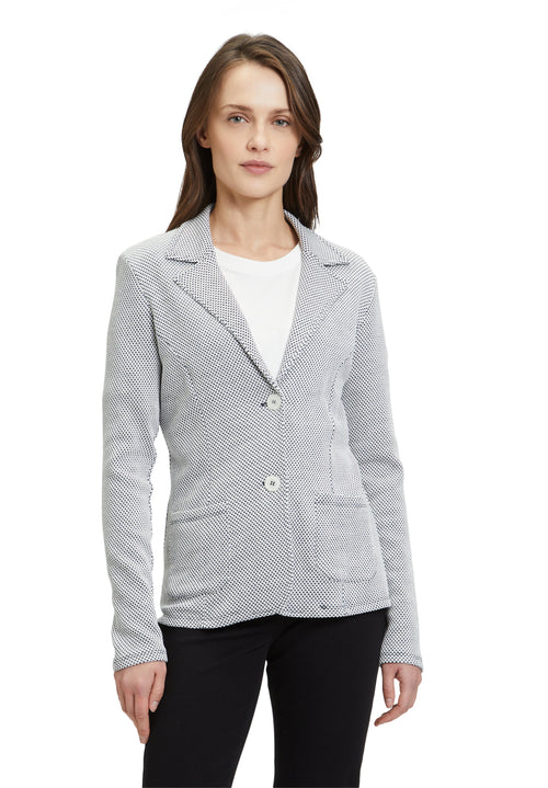 This Betty Barclay T-Shirt Blazer has a single breasted, fitted design. It has button fastenings and patch pockets. The material has a dark grey and cream jersey appearance. 