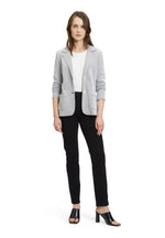 This Betty Barclay T-Shirt Blazer has a single breasted, fitted design. It has button fastenings and patch pockets. The material has a dark grey and cream jersey appearance. 