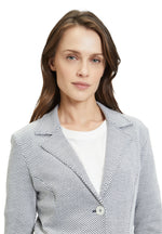 This Betty Barclay T-Shirt Blazer has a single breasted, fitted design. It has button fastenings and patch pockets. The material has a dark grey and cream jersey appearance. 