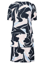 Betty Barclay Tiered Dress. A knee-length straight fit dress, with mid-length sleeves. This dress features an abstract print with pastel blue and pink accents on a navy background.