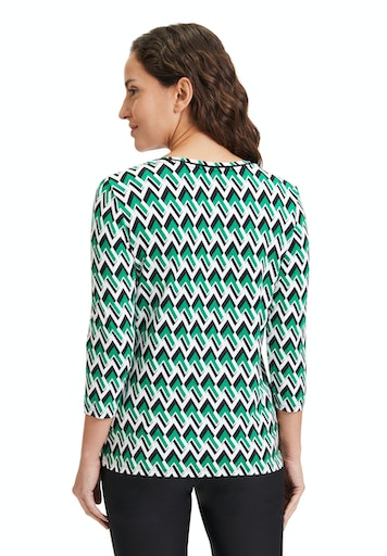 An image of the Betty Barclay Zigzag print top in the colour green, with round neck and 3/4 length sleeves.