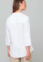 Bianca Linen Adela Blouse. A floaty white blouse with sleeves that fall above the wrist and V-neckline. This blouse also has detailing on the sleeves.