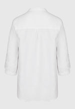 Bianca Linen Adela Blouse. A floaty white blouse with sleeves that fall above the wrist and V-neckline. This blouse also has detailing on the sleeves.