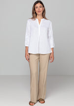 Bianca Linen Adela Blouse. A floaty white blouse with sleeves that fall above the wrist and V-neckline. This blouse also has detailing on the sleeves.