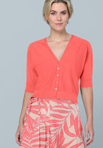 Bianca Oriain Short Sleeve Cardigan. A regular fit short sleeve cardigan with V-neck and button fastenings. This cardigan has a cropped length and is a coral pink colour.