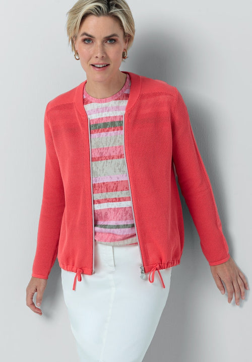 Bianca Samiris Zip Knit. A regular fit, long sleeve jacket with tie hem and motif on the back. The colour is a vibrant coral pink.