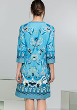 Bianca Danilo 3/4 Sleeve Patterned Dress. A relaxed fit dress with 3/4 length sleeves, knee-length design, and V-neckline. This dress has a vibrant blue pattern.