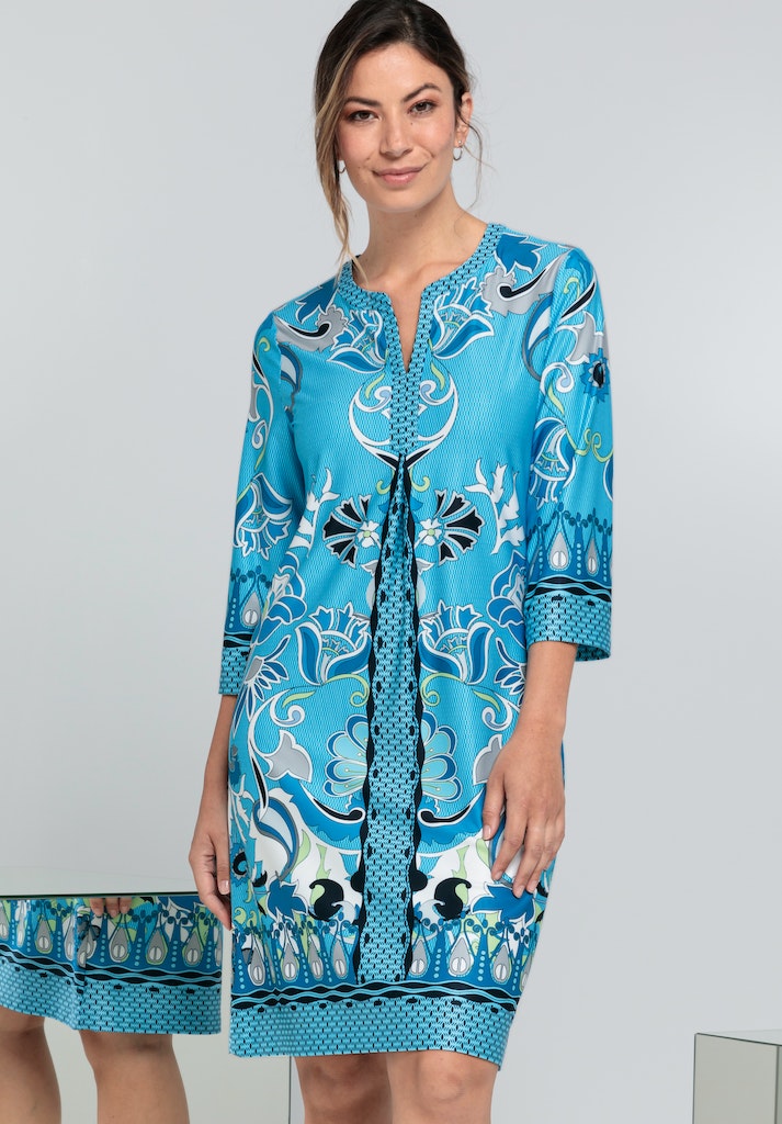 Bianca Danilo 3/4 Sleeve Patterned Dress. A relaxed fit dress with 3/4 length sleeves, knee-length design, and V-neckline. This dress has a vibrant blue pattern.