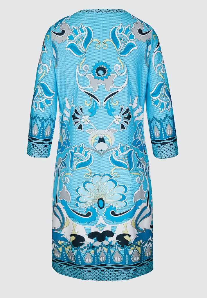 Bianca Danilo 3/4 Sleeve Patterned Dress. A relaxed fit dress with 3/4 length sleeves, knee-length design, and V-neckline. This dress has a vibrant blue pattern.