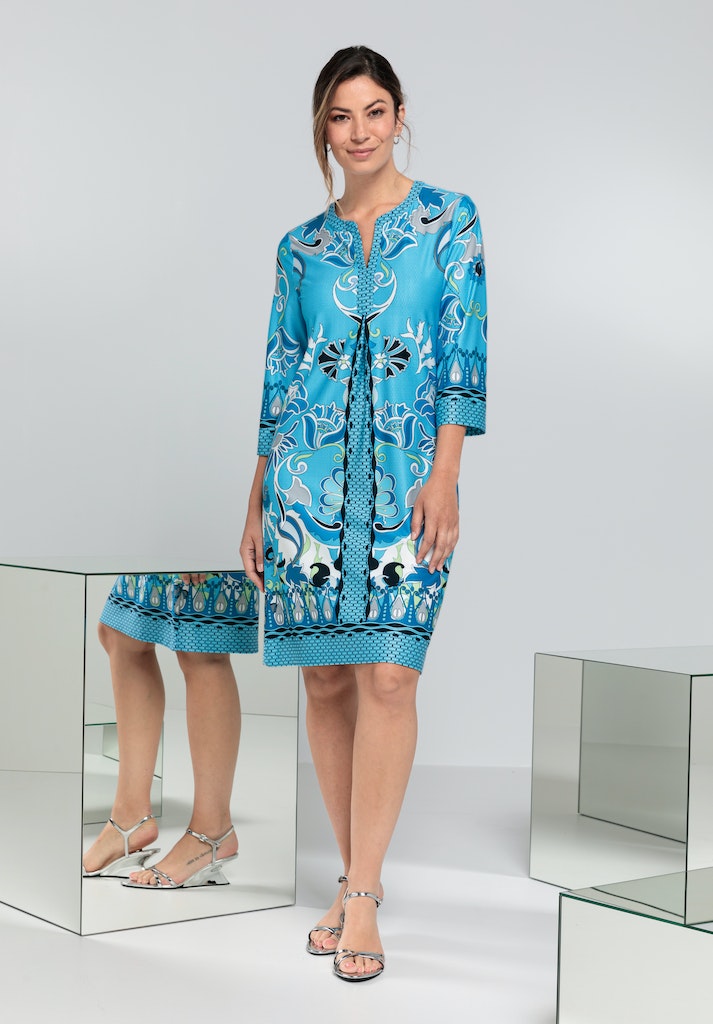 Bianca Danilo 3/4 Sleeve Patterned Dress. A relaxed fit dress with 3/4 length sleeves, knee-length design, and V-neckline. This dress has a vibrant blue pattern.