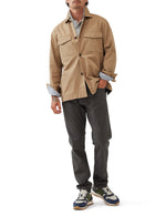 Rodd & Gunn Whitstone Jacket. A beige long sleeve jacket with water-repellent finish, long sleeves and chest pockets.