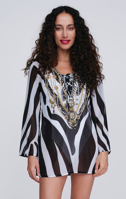 Pia Rossini Bali Cover Up. A lightweight beach tunic with long sleeves and V-neckline. This cover up has a sparkling embellishment and black & white animal print.