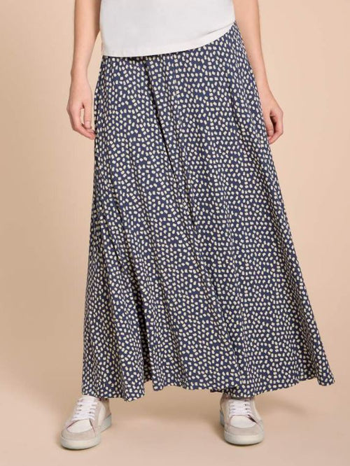 White Stuff Jada Eco Vero Skirt. A maxi skirt with flowy style and an all-over white dotted design on a navy background.