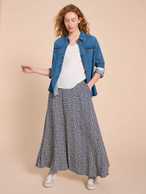 White Stuff Jada Eco Vero Skirt. A maxi skirt with flowy style and an all-over white dotted design on a navy background.