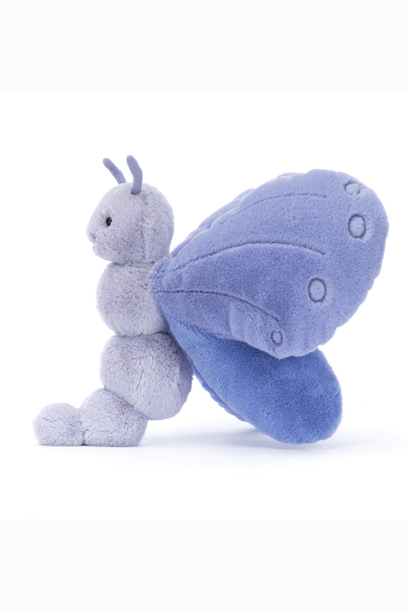 Jellycat Bluebell Butterfly. A soft toy butterfly with indigo and lavender wings, smiling face, and feelers.