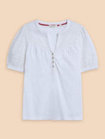 White Stuff Bella Broderie Mix Top. A cotton jersey mix with a feminine notch neckline, and short, broderie cut-out sleeves