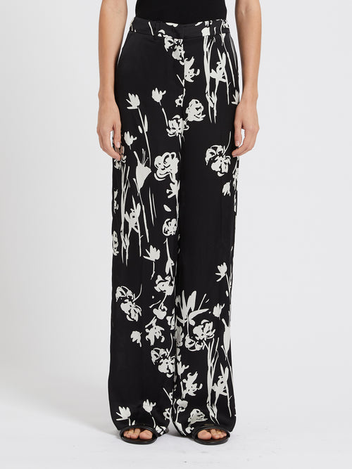Marella Sale Trousers. A pair of wide leg trousers with pockets, zip fastening, and bold black and white floral print.