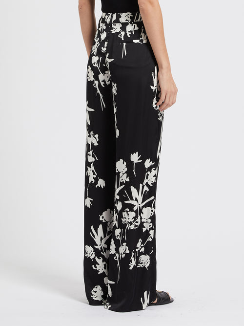 Marella Sale Trousers. A pair of wide leg trousers with pockets, zip fastening, and bold black and white floral print.