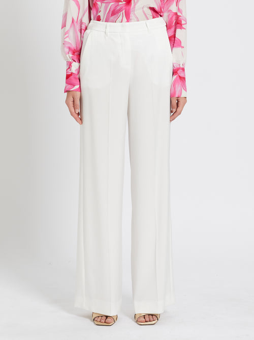 Marella Rita Satin Trousers. A pair of white trousers with wide leg and pressed pleat detail, as well as pockets and zip closure.