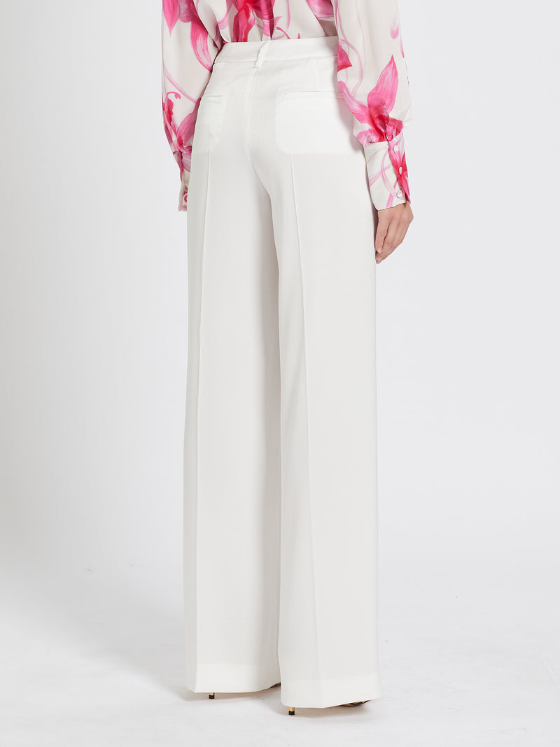 Marella Rita Satin Trousers. A pair of white trousers with wide leg and pressed pleat detail, as well as pockets and zip closure.