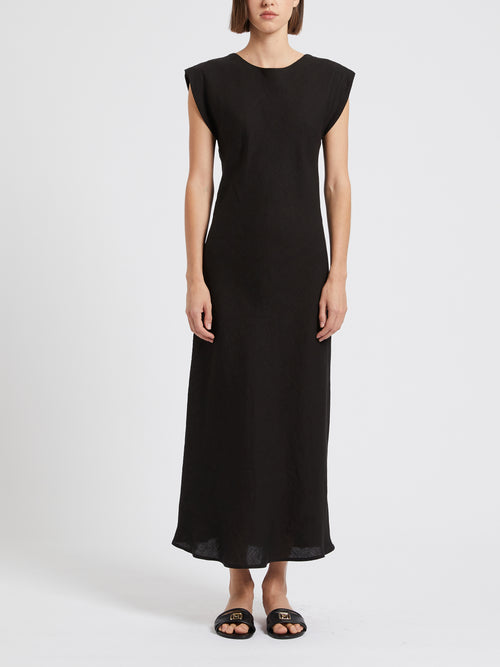 Marella Hidalgo Cap Sleeve Linen Dress. A long dress with short sleeves and boat neck. The back has a V-neck. This dress comes in black linen.