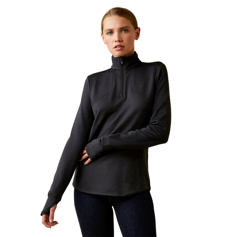 An image of a female model wearing the Ariat Gridwork 1/4 Zip Baselayer in the colour Black.