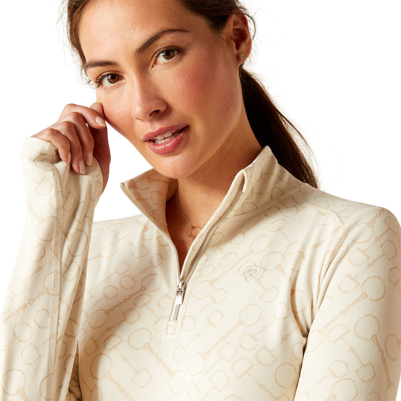 An image of a female model wearing the Ariat Prophecy 1/4 Zip Baselayer in the colour Petrified Oak.